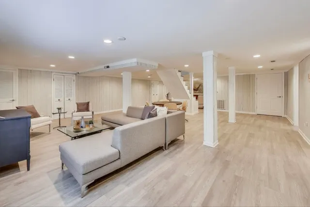 a living room with furniture and kitchen view
