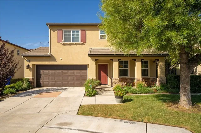 a front view of a house with garden