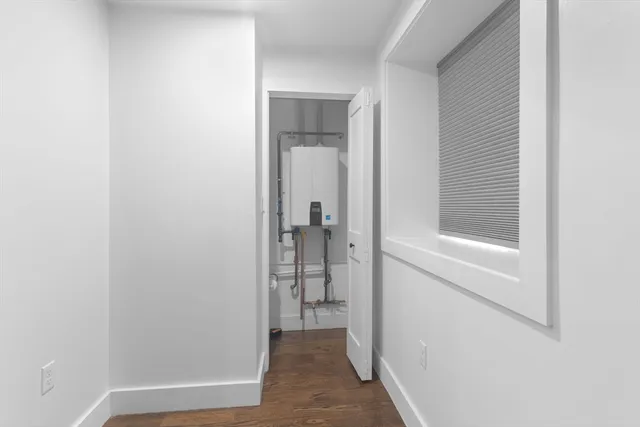 a view of a hallway with wooden shelves