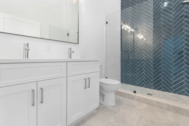 a bathroom with a toilet and a shower