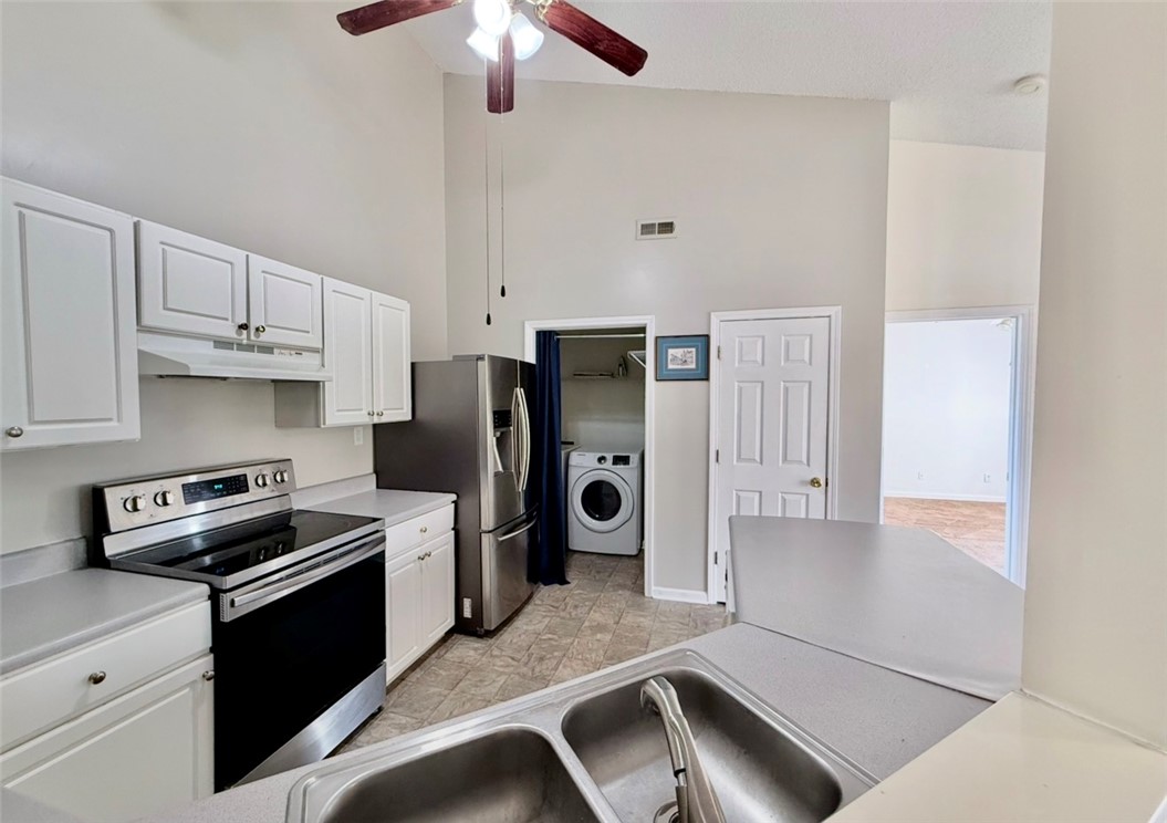 151 Wexford Drive, Unit 301 Anderson, SC 29621 - Photo 14 of 29 This spacious kitchen offers ample cabinet space and modern appliances, with an adjacent laundry area.