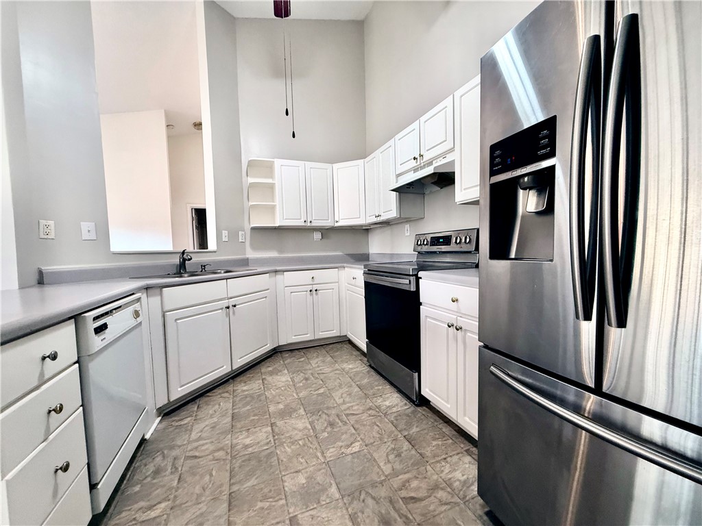 151 Wexford Drive, Unit 301 Anderson, SC 29621 - Photo 15 of 29 This modern kitchen features crisp white cabinetry and essential appliances for daily living.