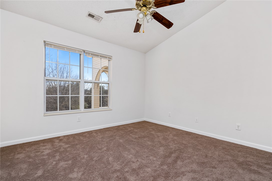 151 Wexford Drive, Unit 301 Anderson, SC 29621 - Photo 22 of 29 This airy bedroom features high ceilings and a broad window.