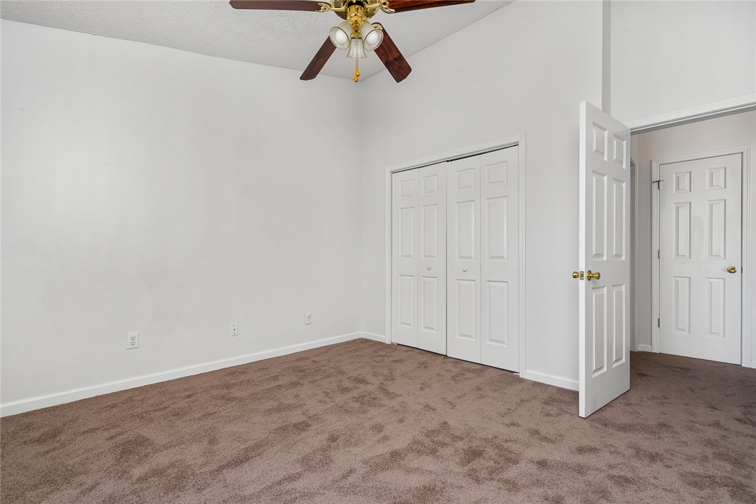 151 Wexford Drive, Unit 301 Anderson, SC 29621 - Photo 23 of 29 This spacious bedroom offers comfortable carpeting and a convenient ceiling fan for optimal airflow.