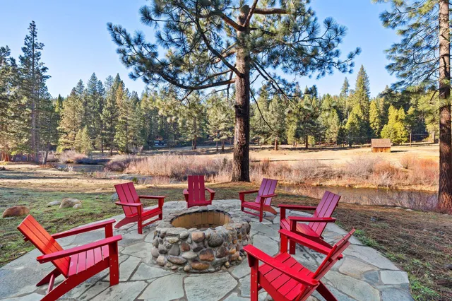 an outdoor sitting area with furniture and wooden floor