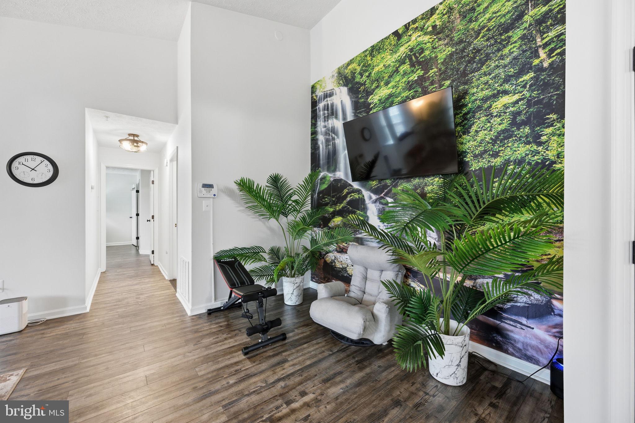 695 Winding Stream Way, Unit 301 Odenton, MD 21113 - Photo 13 of 25 a living room with furniture and a potted plant