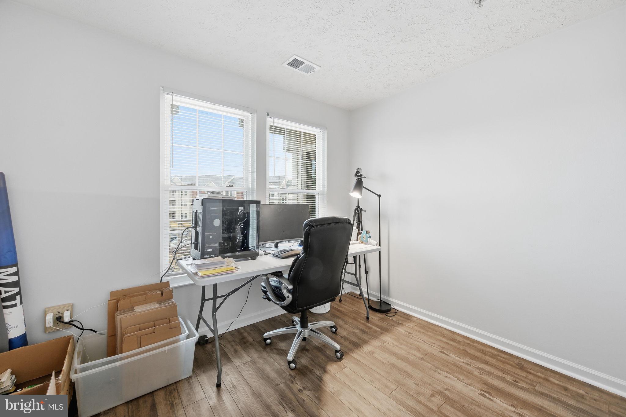 695 Winding Stream Way, Unit 301 Odenton, MD 21113 - Photo 6 of 25 a view of a workspace with furniture and a window
