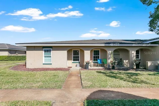 a front view of house with yard outdoor seating and barbeque oven
