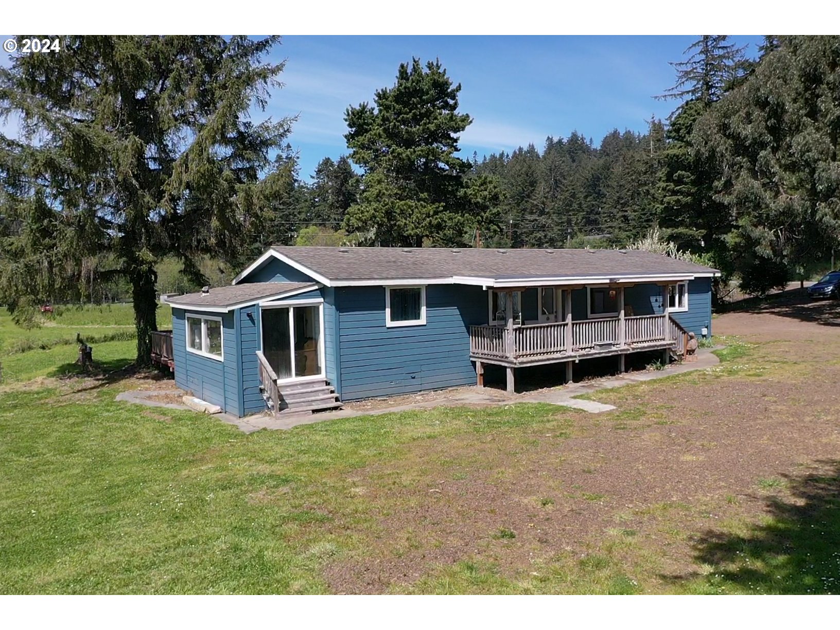 28358 Mateer Road Gold Beach, OR 97444 - Photo 3 of 48 a view of a house with a yard