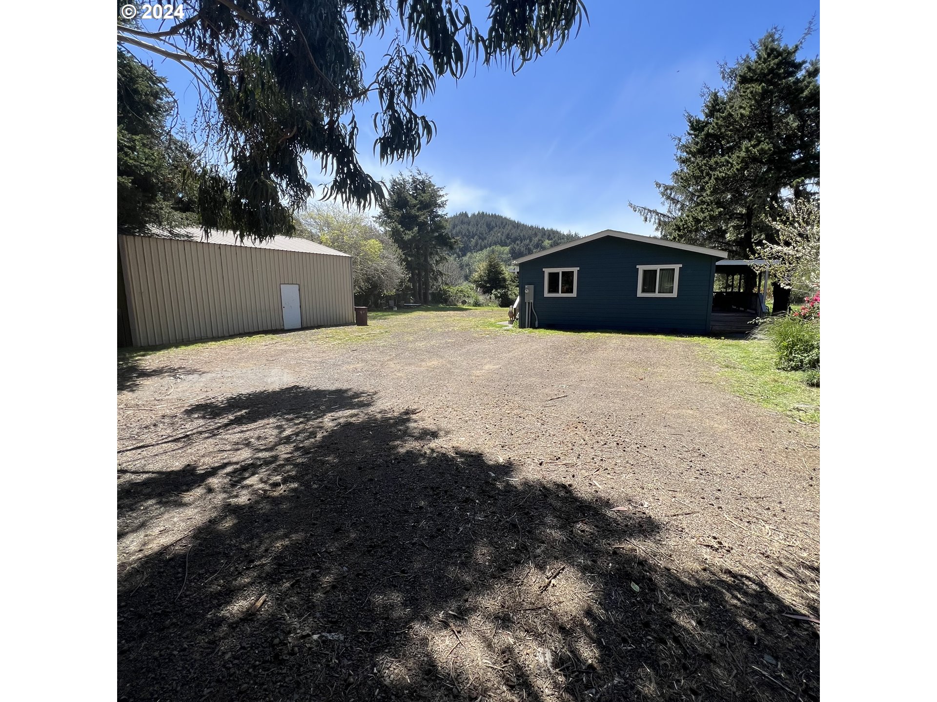 28358 Mateer Road Gold Beach, OR 97444 - Photo 35 of 48 a view of a house with a yard