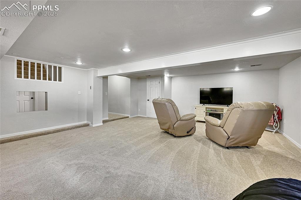 17350 Goshawk Road Colorado Springs, CO 80908 - Photo 27 of 50 a living room with furniture and a flat screen tv