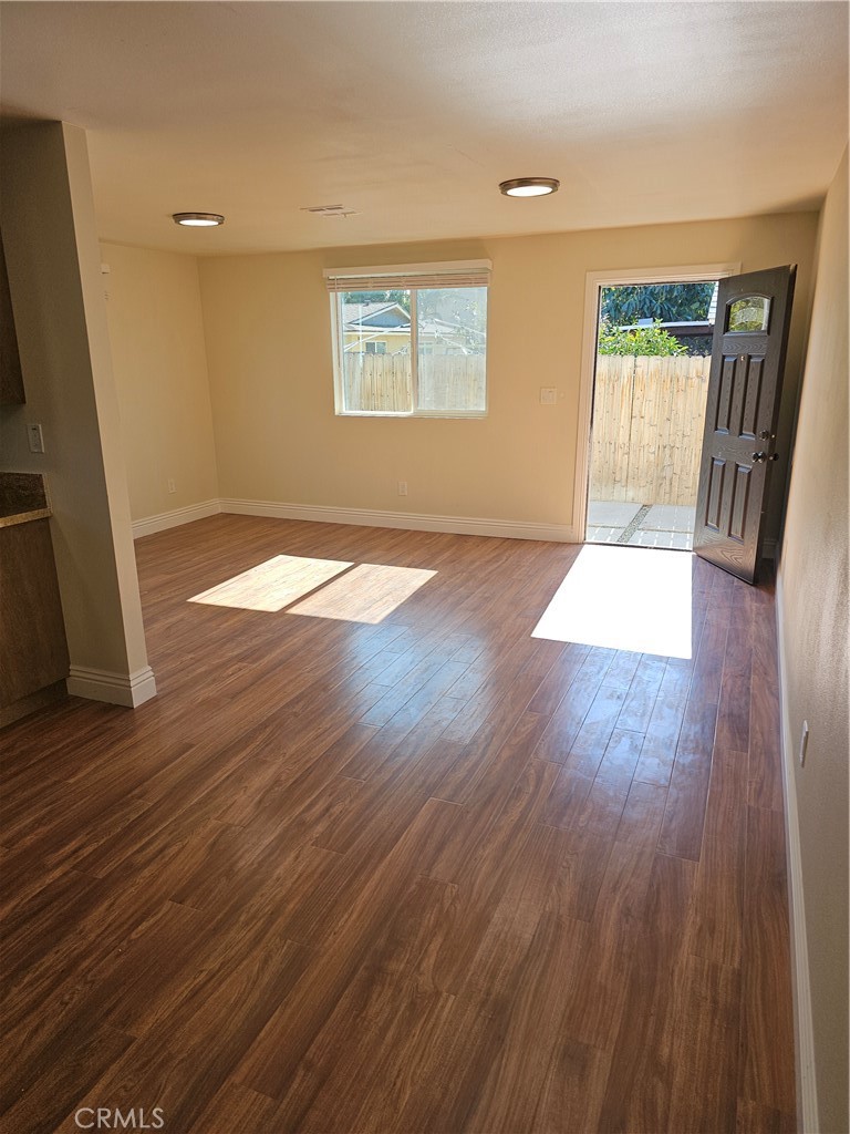 587 North Orange Street Orange, CA 92867 - Photo 4 of 15 an empty room with wooden floor and windows