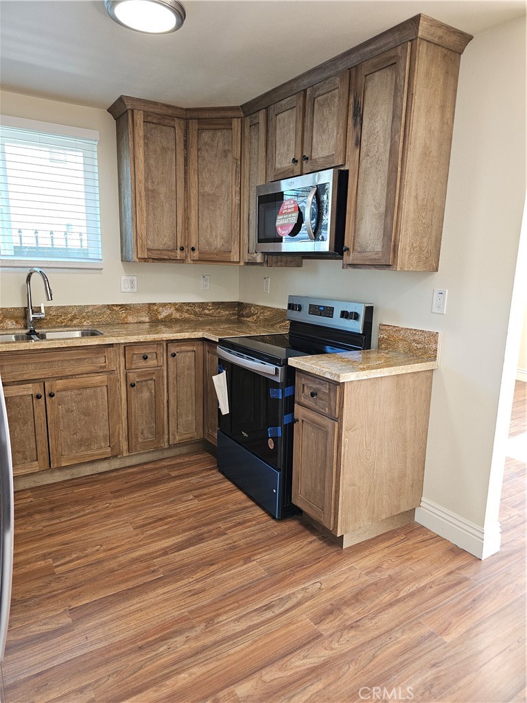 587 North Orange Street Orange, CA 92867 - Photo 5 of 15 a kitchen with stainless steel appliances granite countertop a stove a sink and a microwave