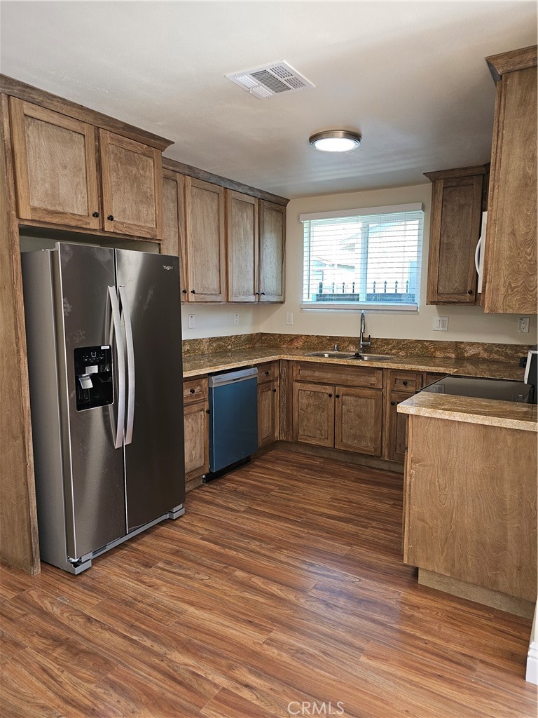 587 North Orange Street Orange, CA 92867 - Photo 6 of 15 a kitchen with stainless steel appliances granite countertop a sink stove and refrigerator