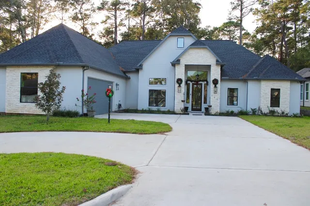 a front view of a house with garden
