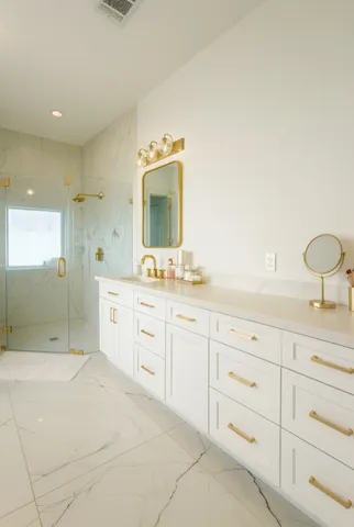 a spacious bathroom with double sink and a mirror