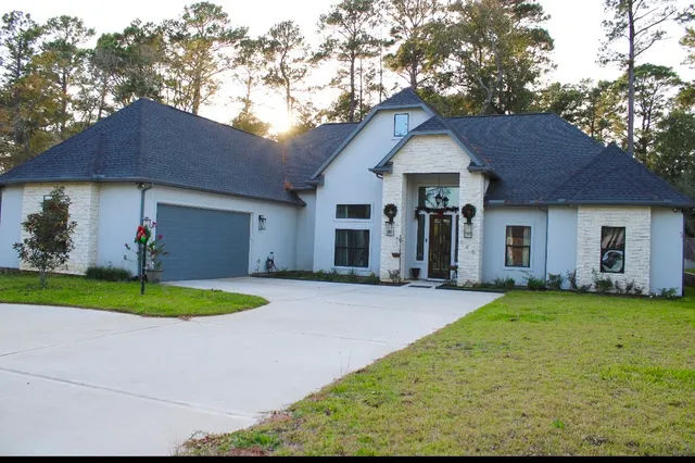 a front view of a house with a yard and garage