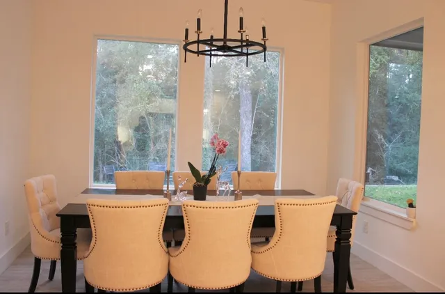 a dining room with furniture a window and a wooden floor