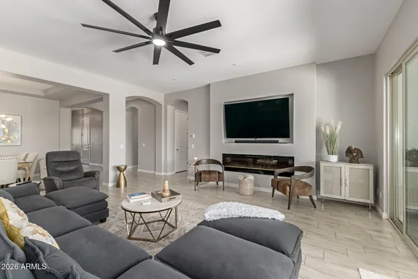 a living room with furniture and a view of kitchen