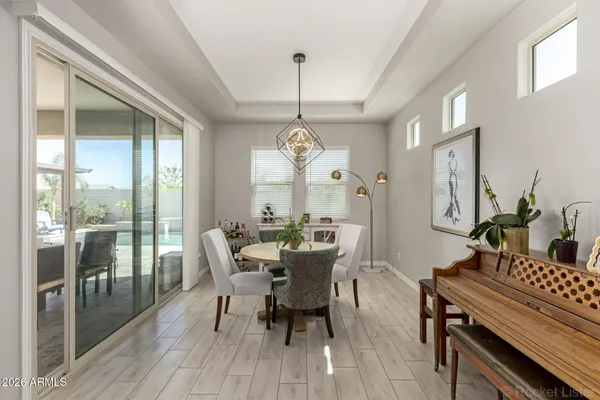 a kitchen with stainless steel appliances granite countertop a sink a stove a refrigerator and island with wooden floor