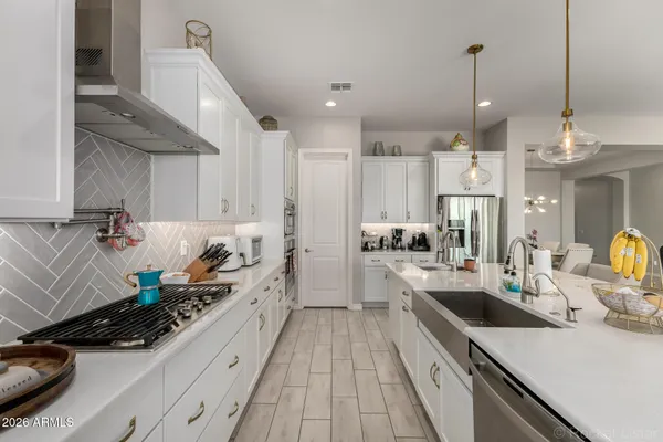 a kitchen with sink stove and cabinets