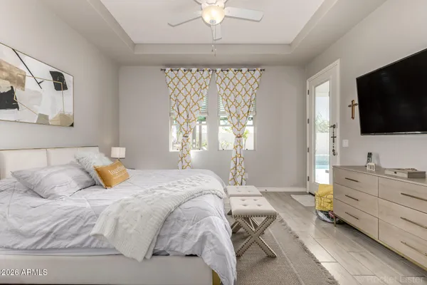 a bedroom with a large bed couch and a window