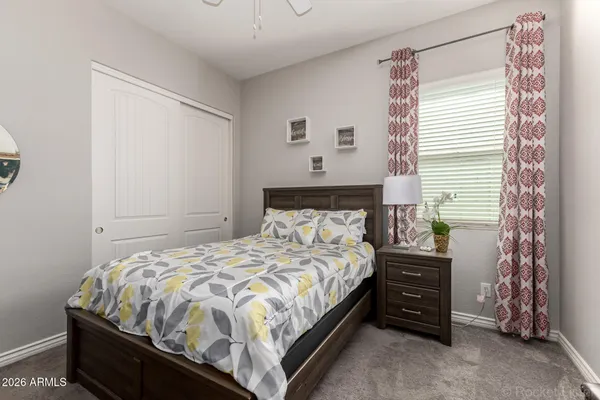 a bedroom with a bed and a chair