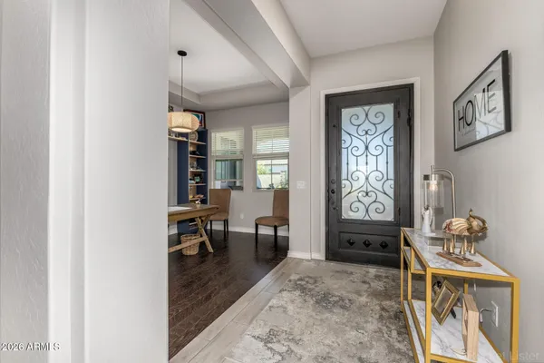 a living room with furniture and a large window with kitchen view