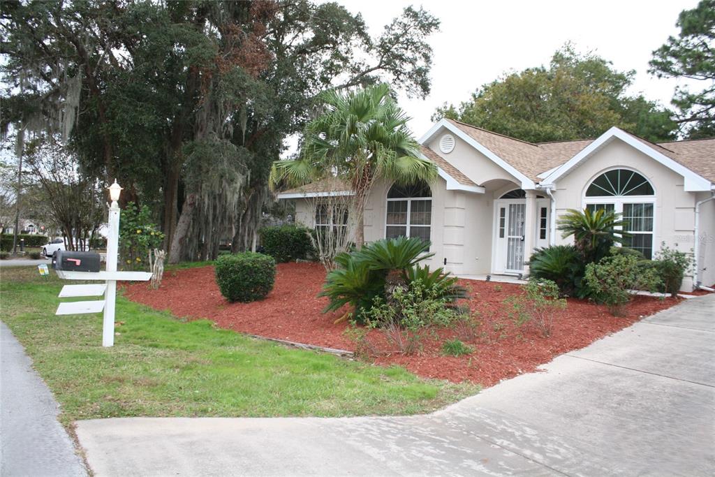 8473 Southwest 108th Pl Road Ocala, FL 34481 - Photo 1 of 1 a front view of a house with a garden
