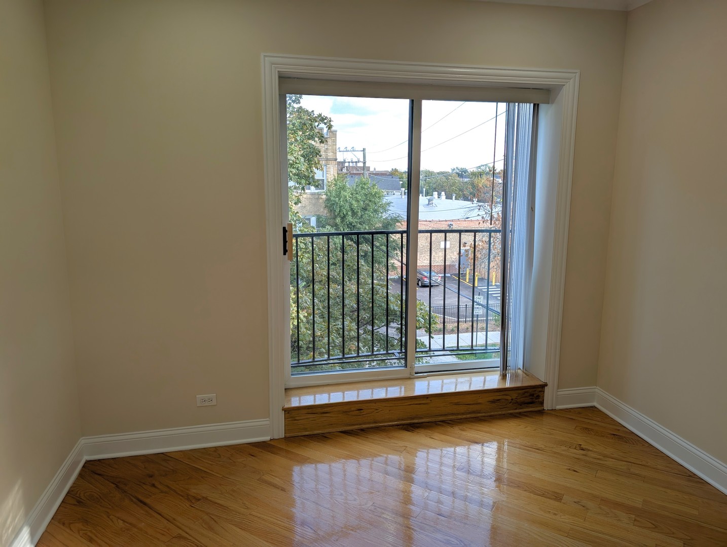 4014 North Central Park Avenue, Unit 3E Chicago, IL 60618 - Photo 2 of 11 a view of an empty room with wooden floor and a window
