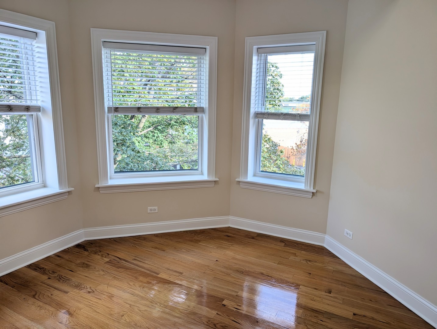 4014 North Central Park Avenue, Unit 3E Chicago, IL 60618 - Photo 9 of 11 a view of an empty room with wooden floor and a window