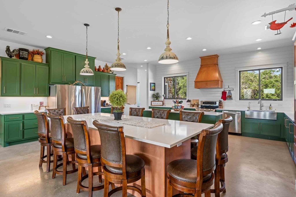 147 Gray Wolf Blanco, TX 78606 - Photo 13 of 34 a kitchen with stainless steel appliances kitchen island a table and chairs in it