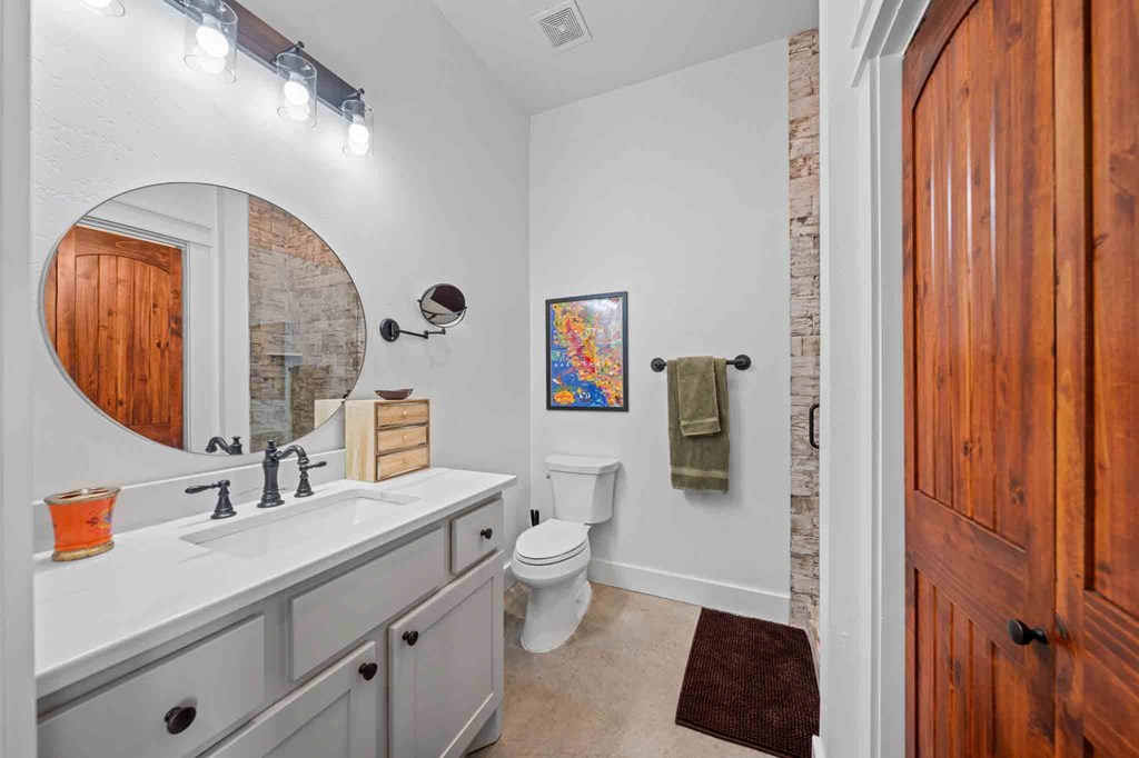 147 Gray Wolf Blanco, TX 78606 - Photo 26 of 34 a bathroom with a sink a toilet and a mirror