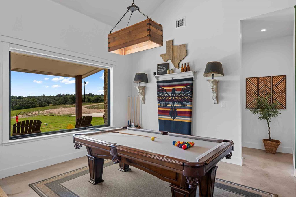 147 Gray Wolf Blanco, TX 78606 - Photo 10 of 34 a living room with furniture pool table and a large window