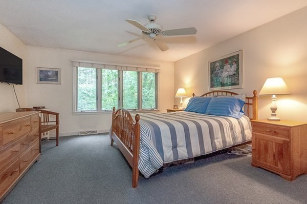 28 Register Road Marion, MA 02738 - Photo 22 of 36 a spacious bedroom with a bed and a ceiling fan