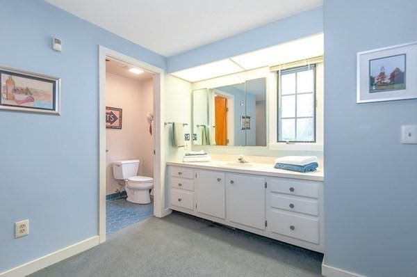 28 Register Road Marion, MA 02738 - Photo 24 of 36 a spacious bathroom with a double vanity sink a large mirror and a toilet