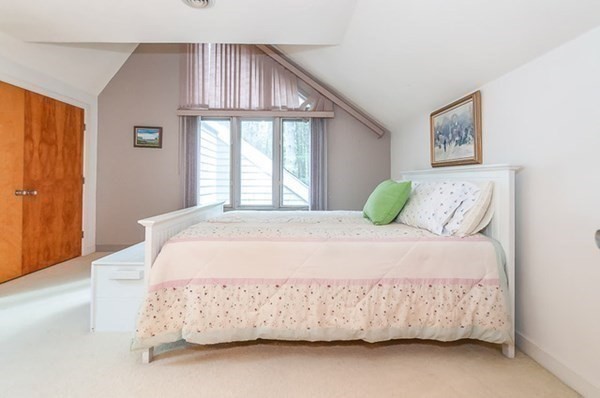 28 Register Road Marion, MA 02738 - Photo 27 of 36 a large bed sitting in a bedroom next to a window