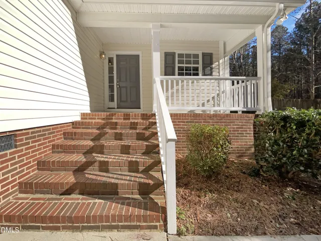 a view of house with backyard