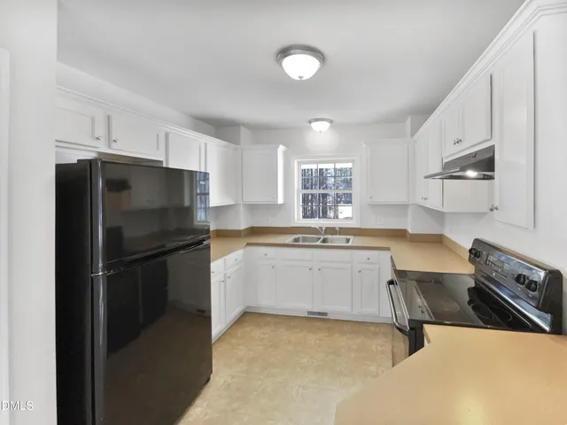 a kitchen with a refrigerator stove and sink