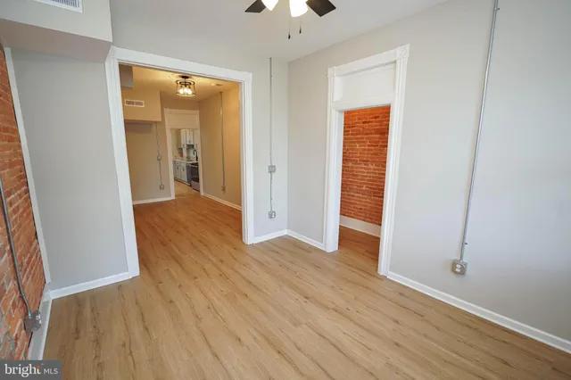 a view of hallway with wooden floor