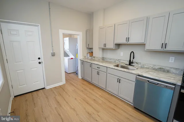 a view of kitchen with furniture refrigerator and wooden floor