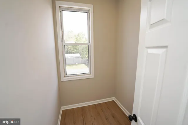a view of an empty room and wooden floor