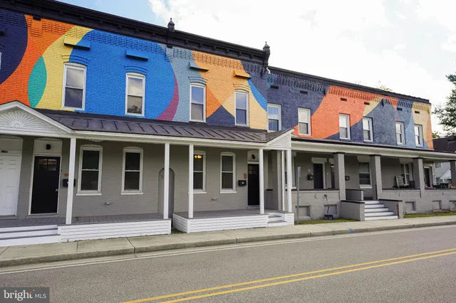 a front view of a building with many windows
