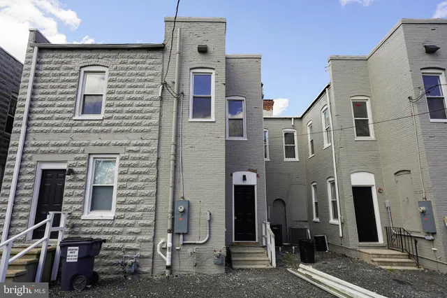 a view of a hallway with wooden floor and a window