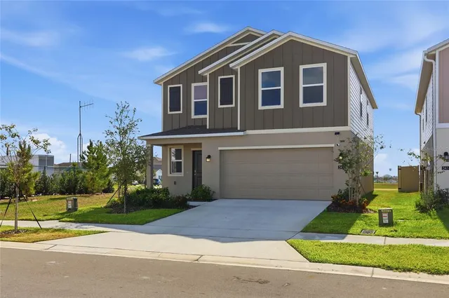 a front view of house with yard and green space