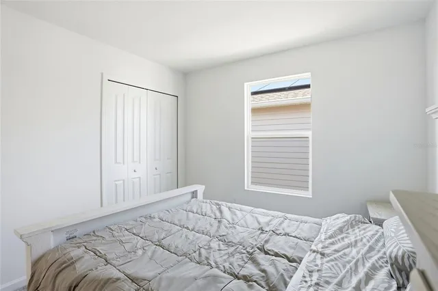 a bedroom with a bed and a window