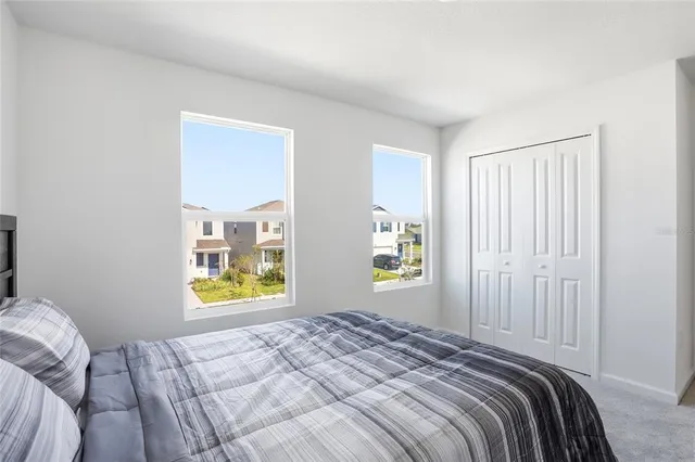 a bedroom with a bed and a window