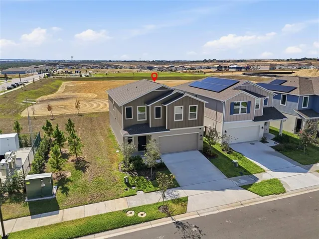 an aerial view of residential houses with outdoor space