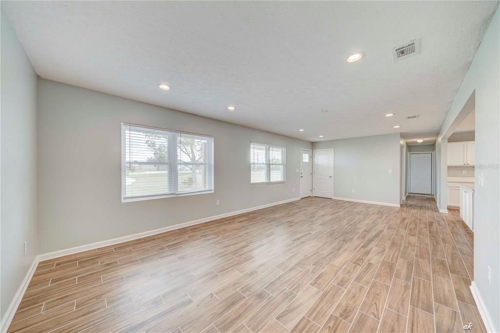 5338 Frank Hough Road Panama City, FL 32404 - Photo 16 of 29 a view of empty room with wooden floor and fan