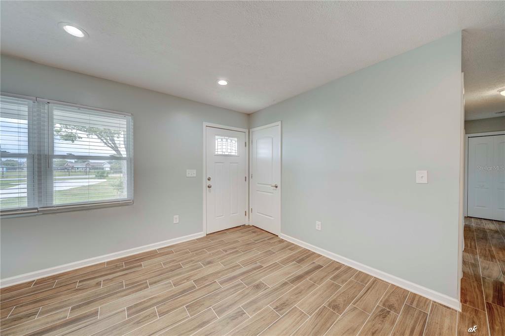 5338 Frank Hough Road Panama City, FL 32404 - Photo 20 of 29 a view of an empty room with wooden floor and a window